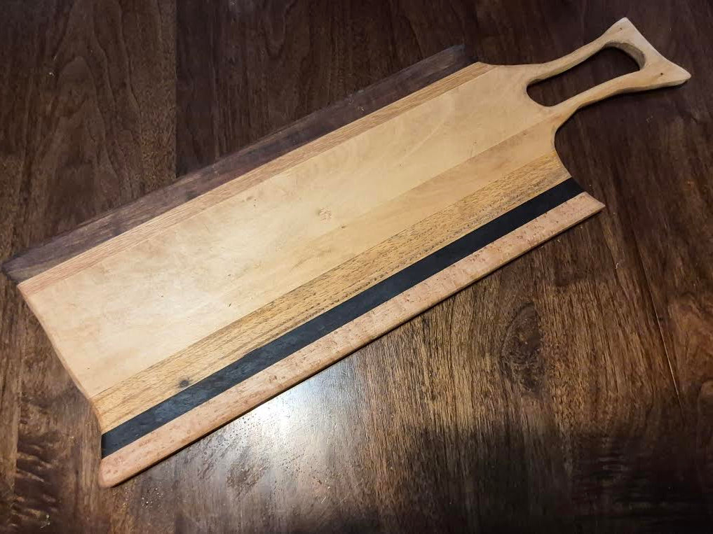 Multi-wood Charcuterie board. 8.5 x 26.5 inches