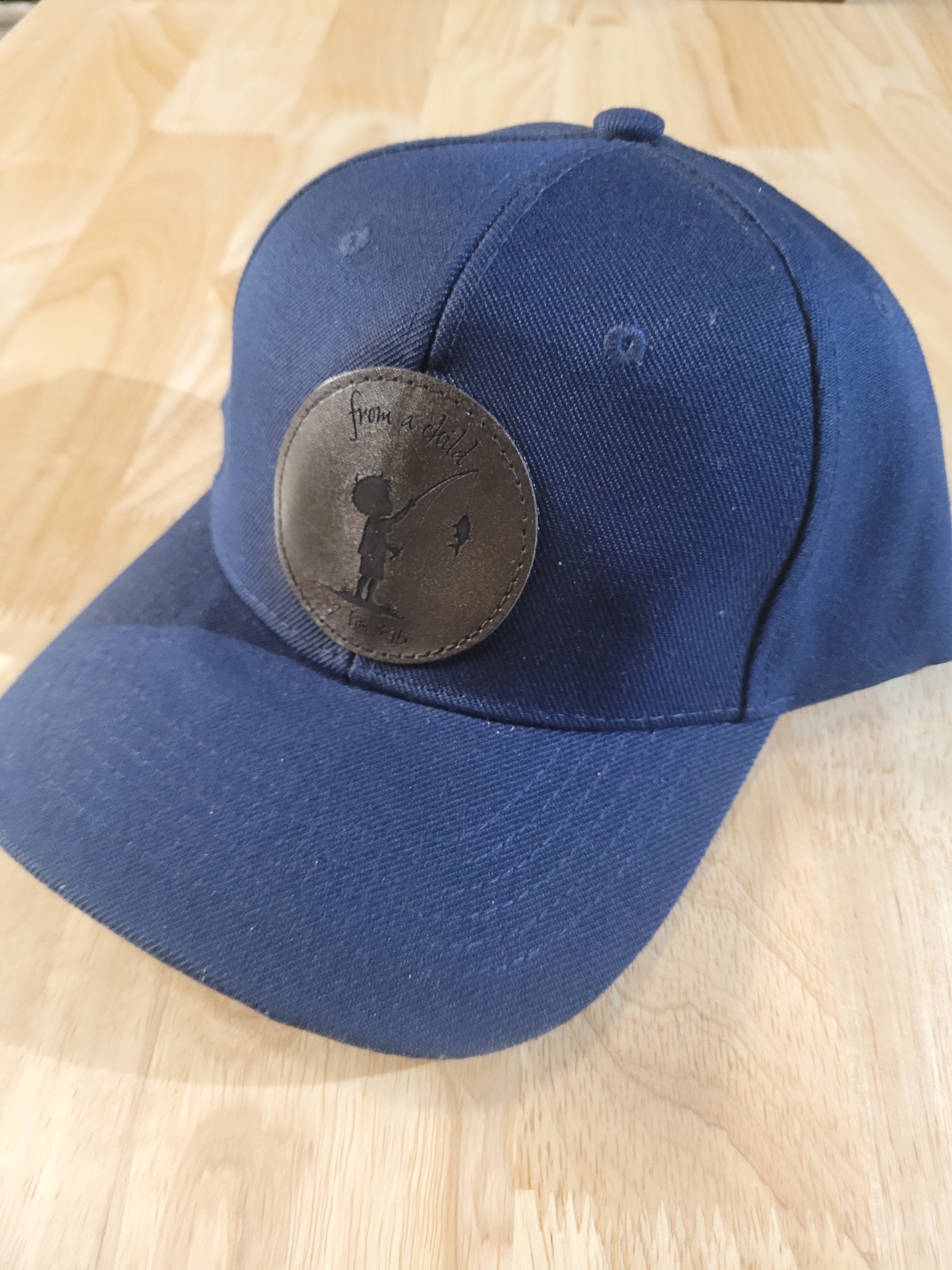 Blue Ball Cap with "from a child 2Tim 3:15" little boy fishing engraved patch