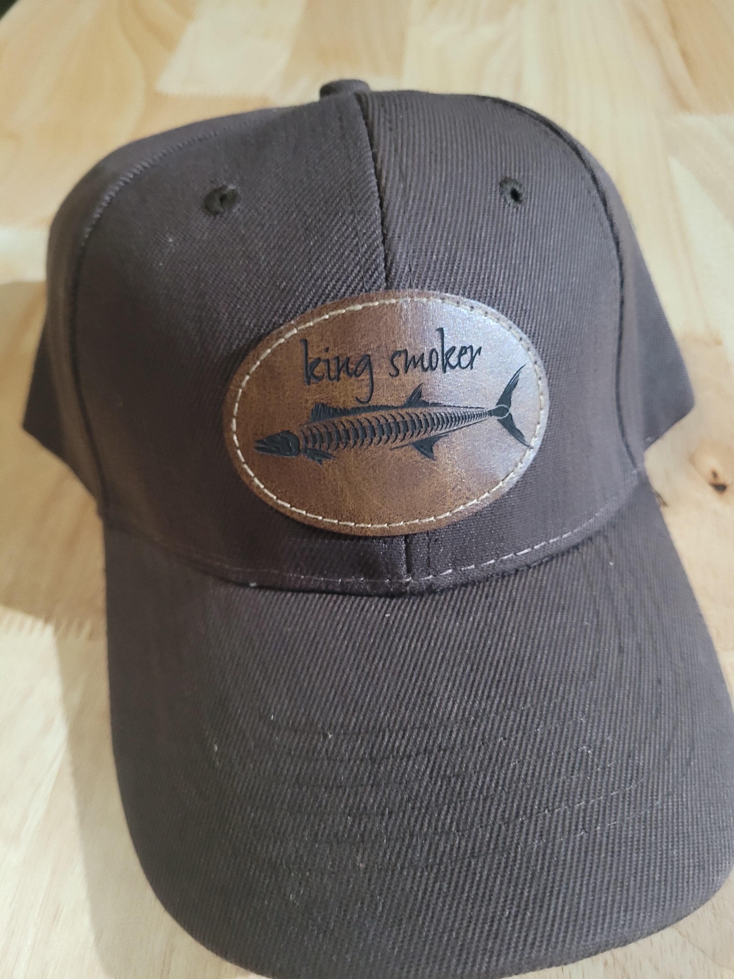 "King Smoker"  Brown Ball Cap with a  King Mackerel Fish Skeleton