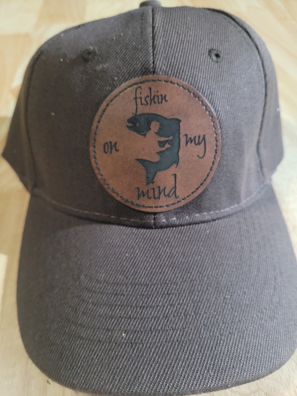 "Fishin On My Mind" patch on a Brown Ball Cap