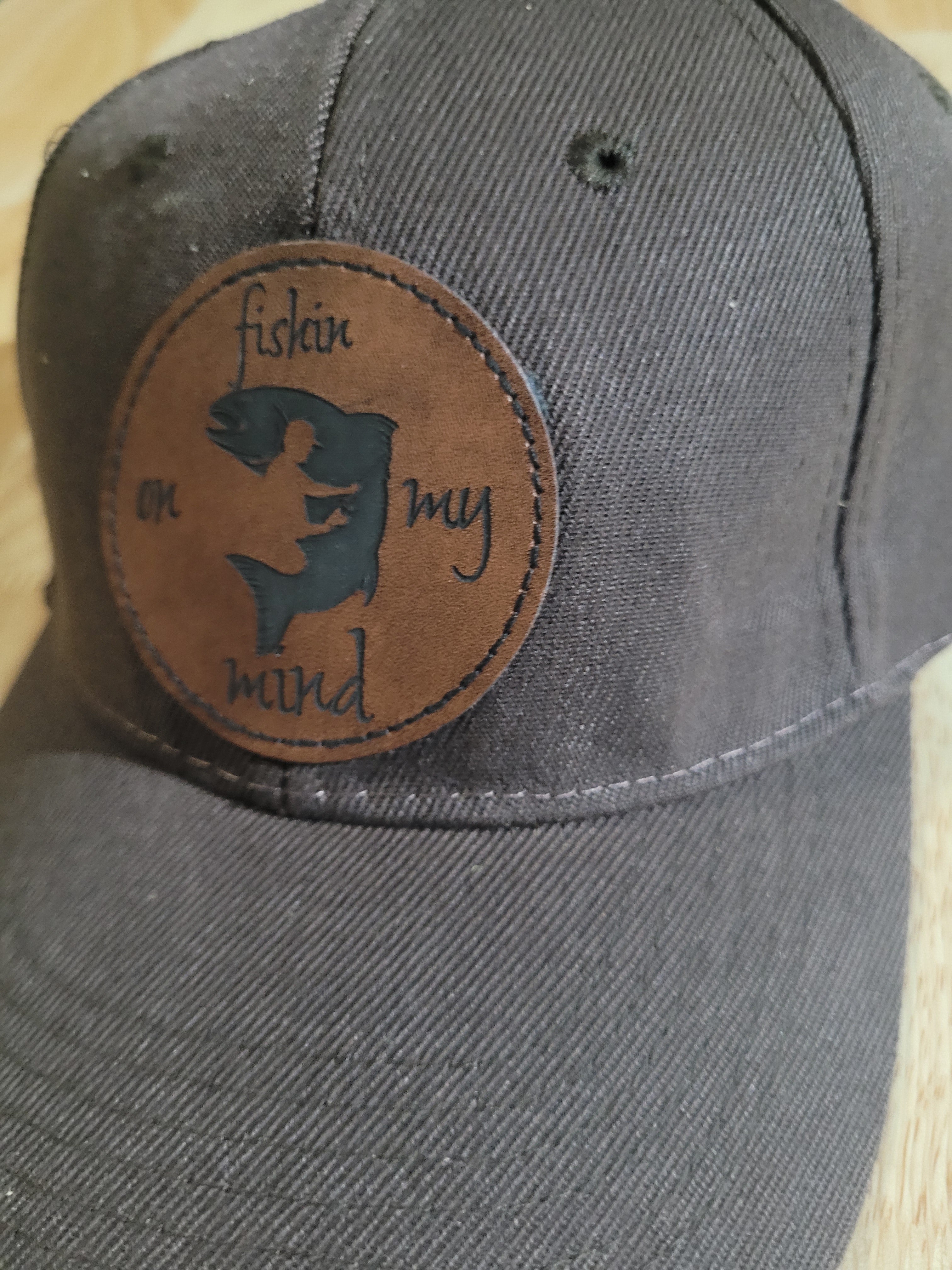"Fishin On My Mind" patch on a Brown Ball Cap