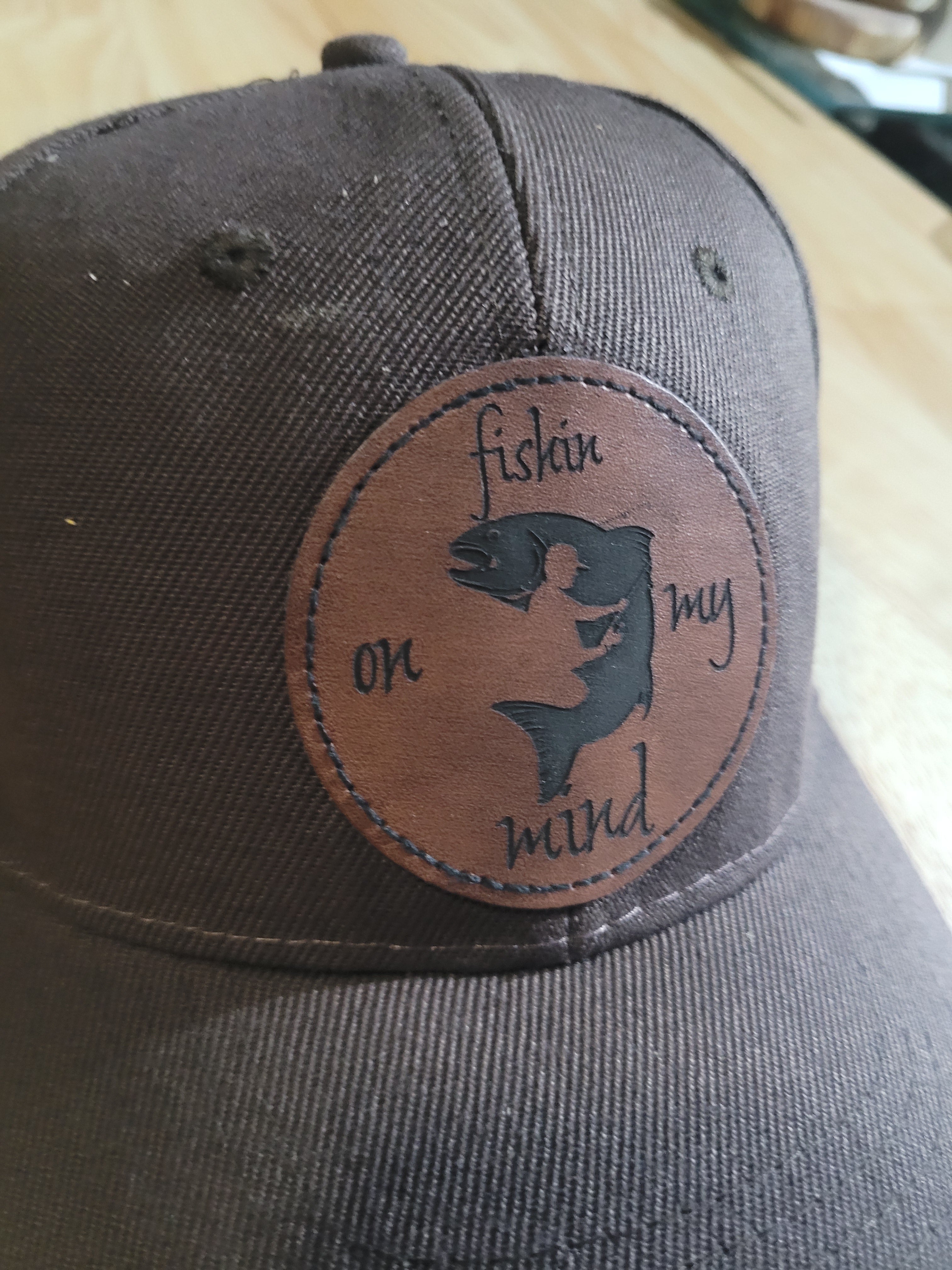 "Fishin On My Mind" patch on a Brown Ball Cap