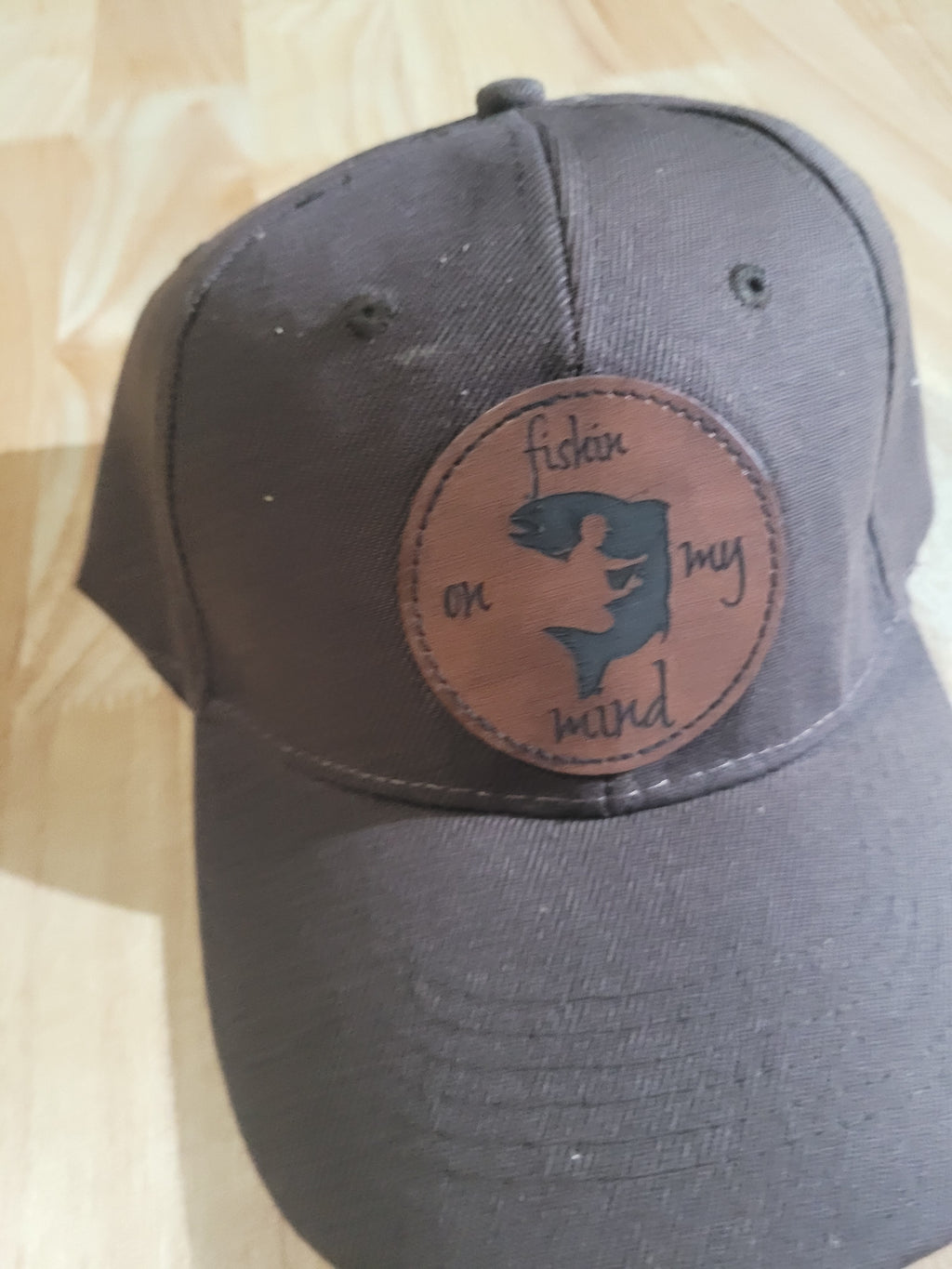 "Fishin On My Mind" patch on a Brown Ball Cap