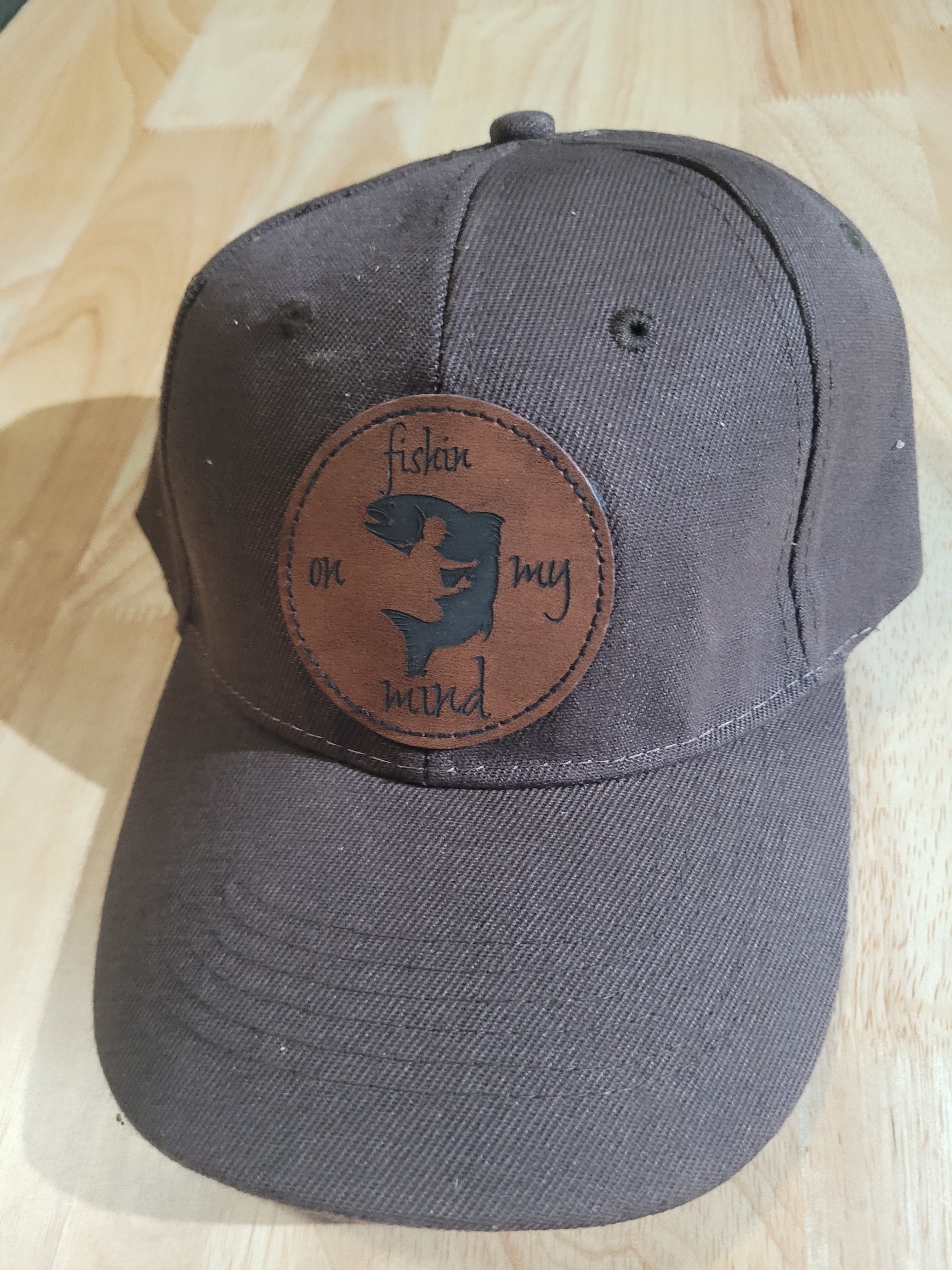 "Fishin On My Mind" patch on a Brown Ball Cap