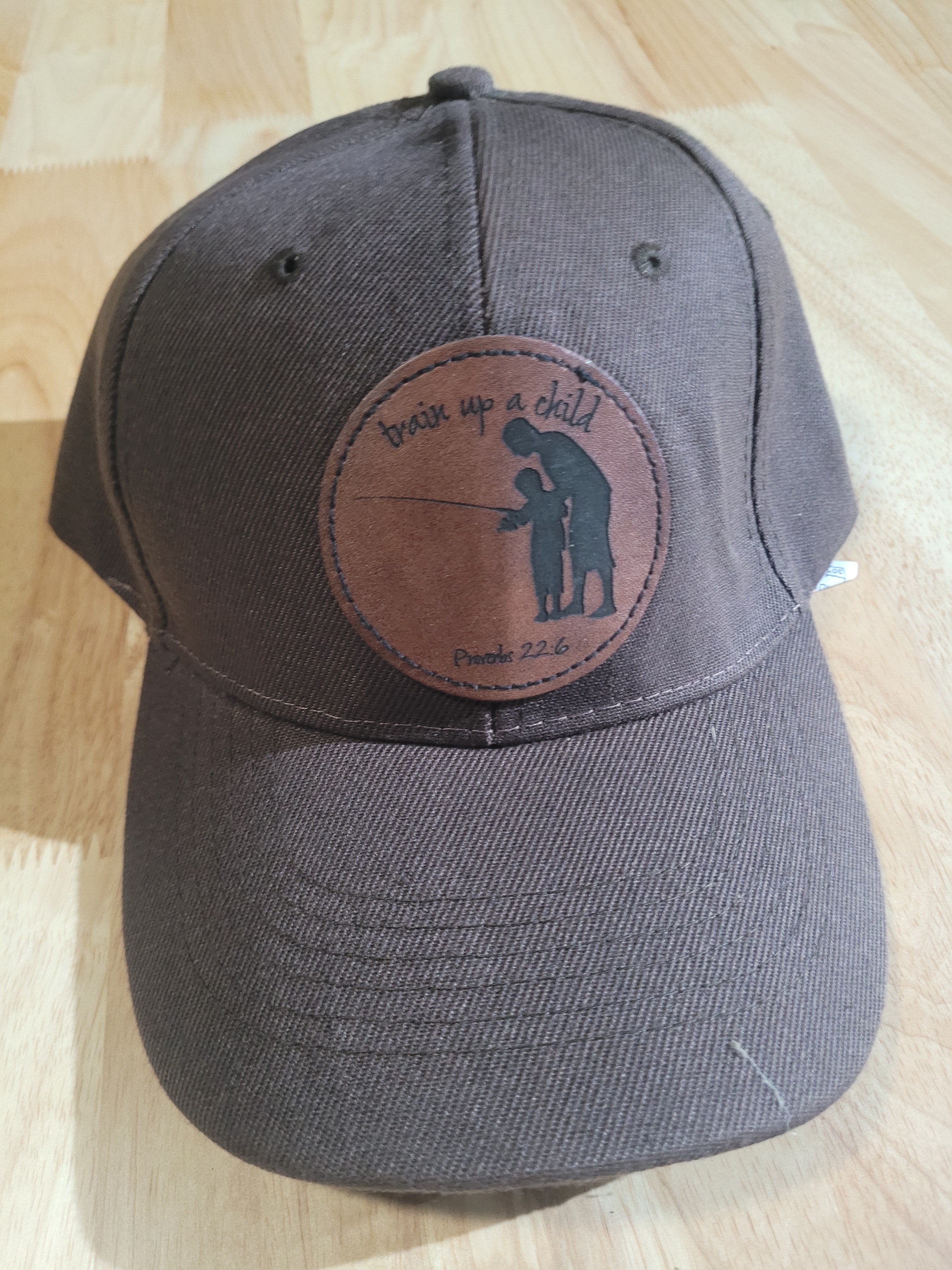 Brown Ball Cap with a patch of a father and son "train up a child Proverbs 22:6"