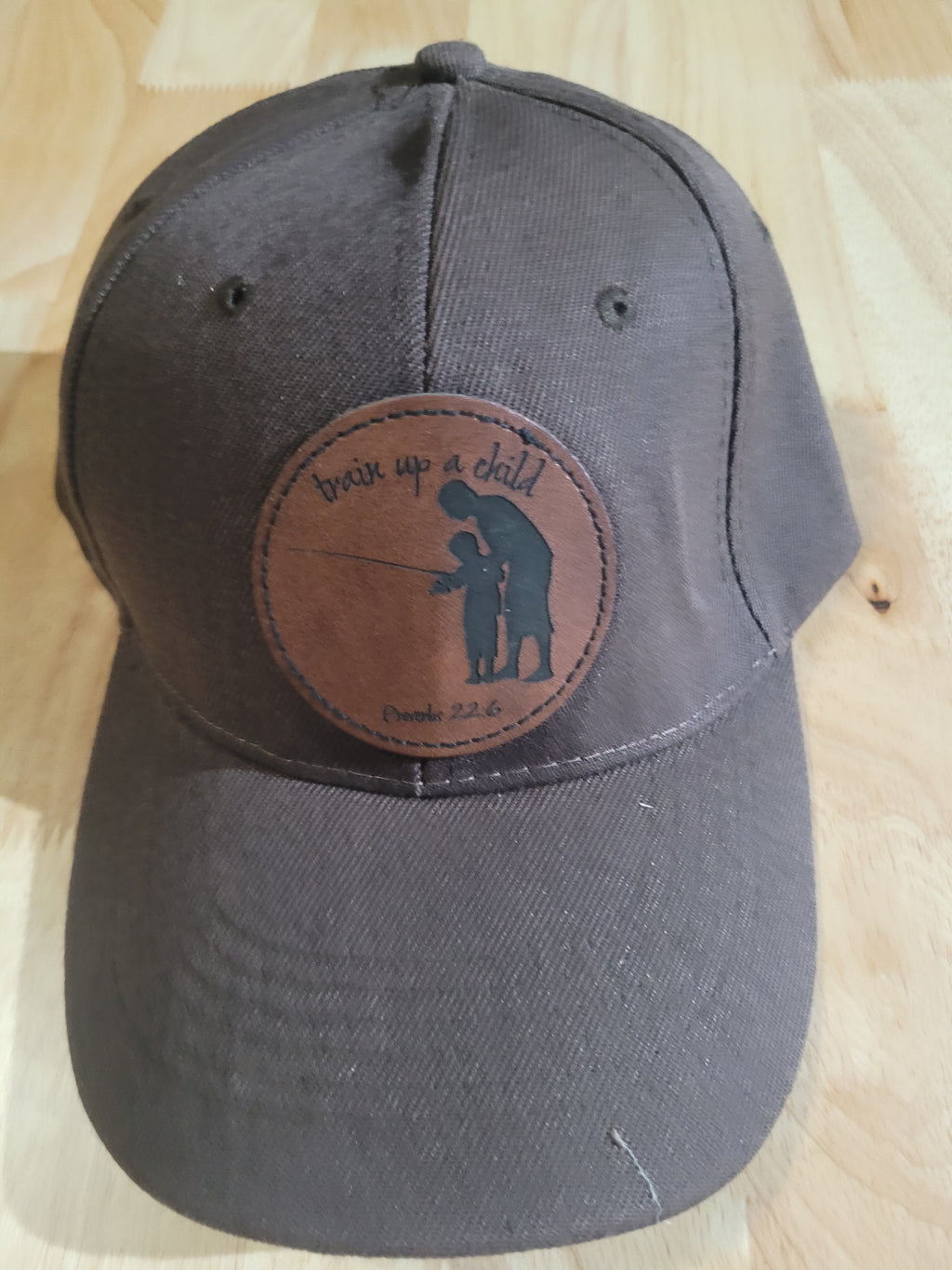 Brown Ball Cap with a patch of a father and son "train up a child Proverbs 22:6"