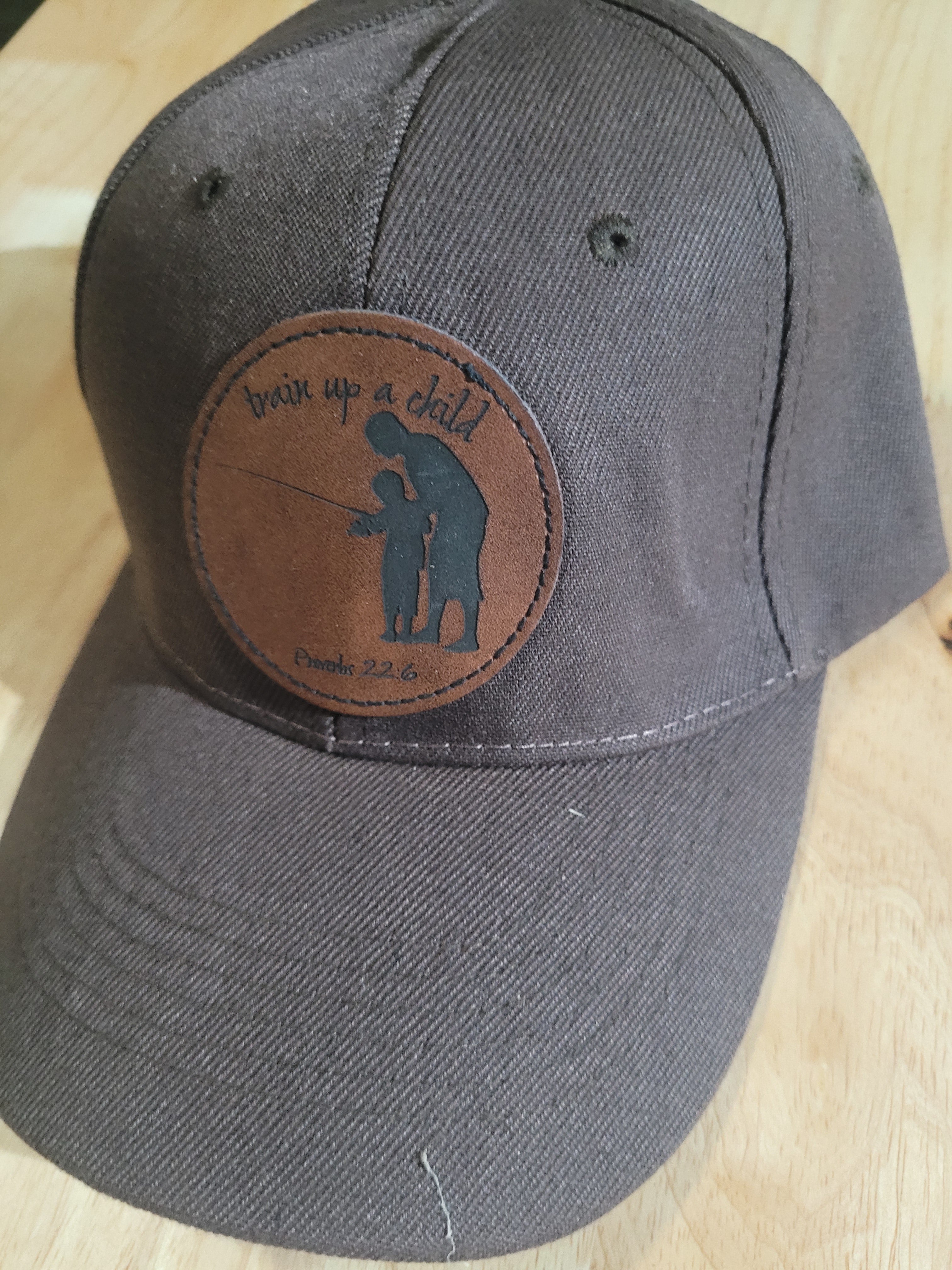 Brown Ball Cap with a patch of a father and son "train up a child Proverbs 22:6"