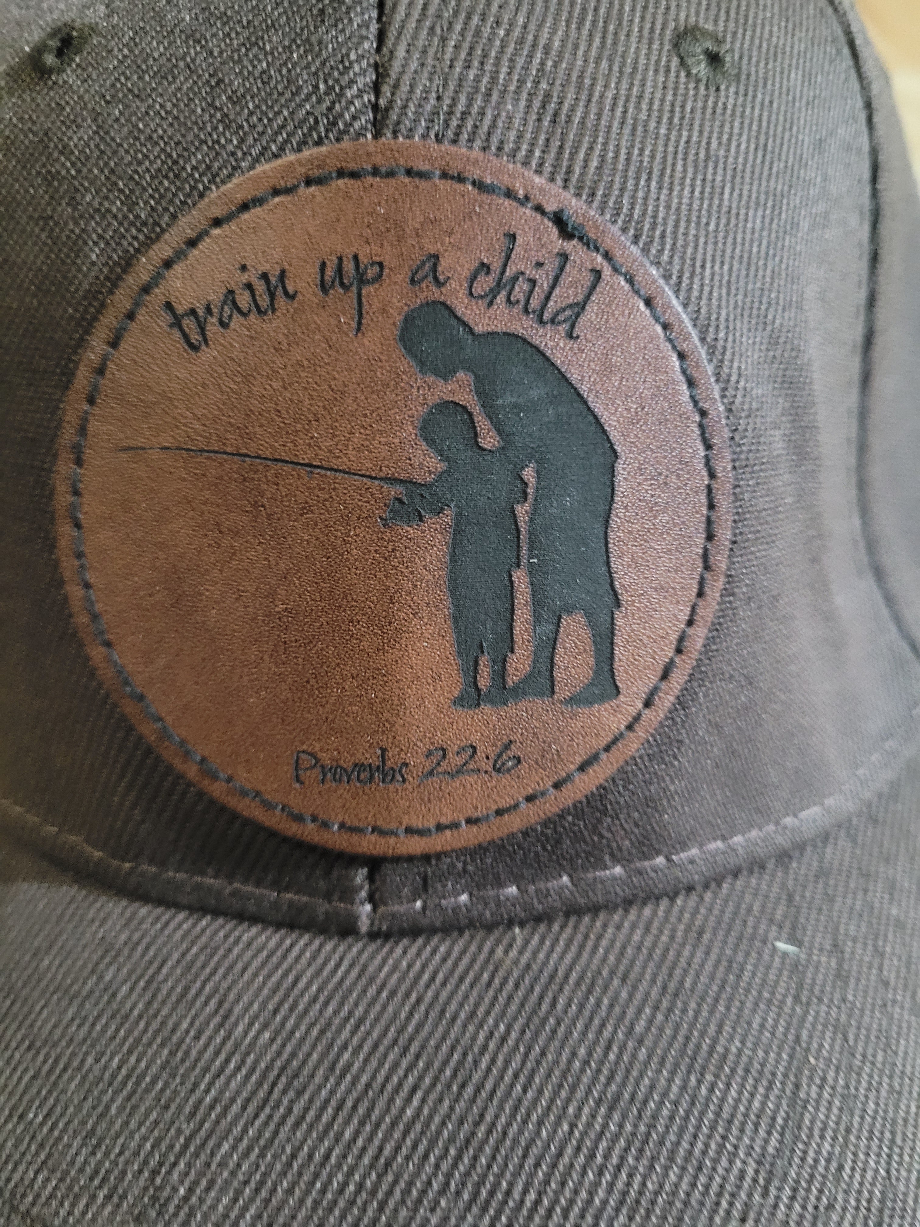 Brown Ball Cap with a patch of a father and son "train up a child Proverbs 22:6"