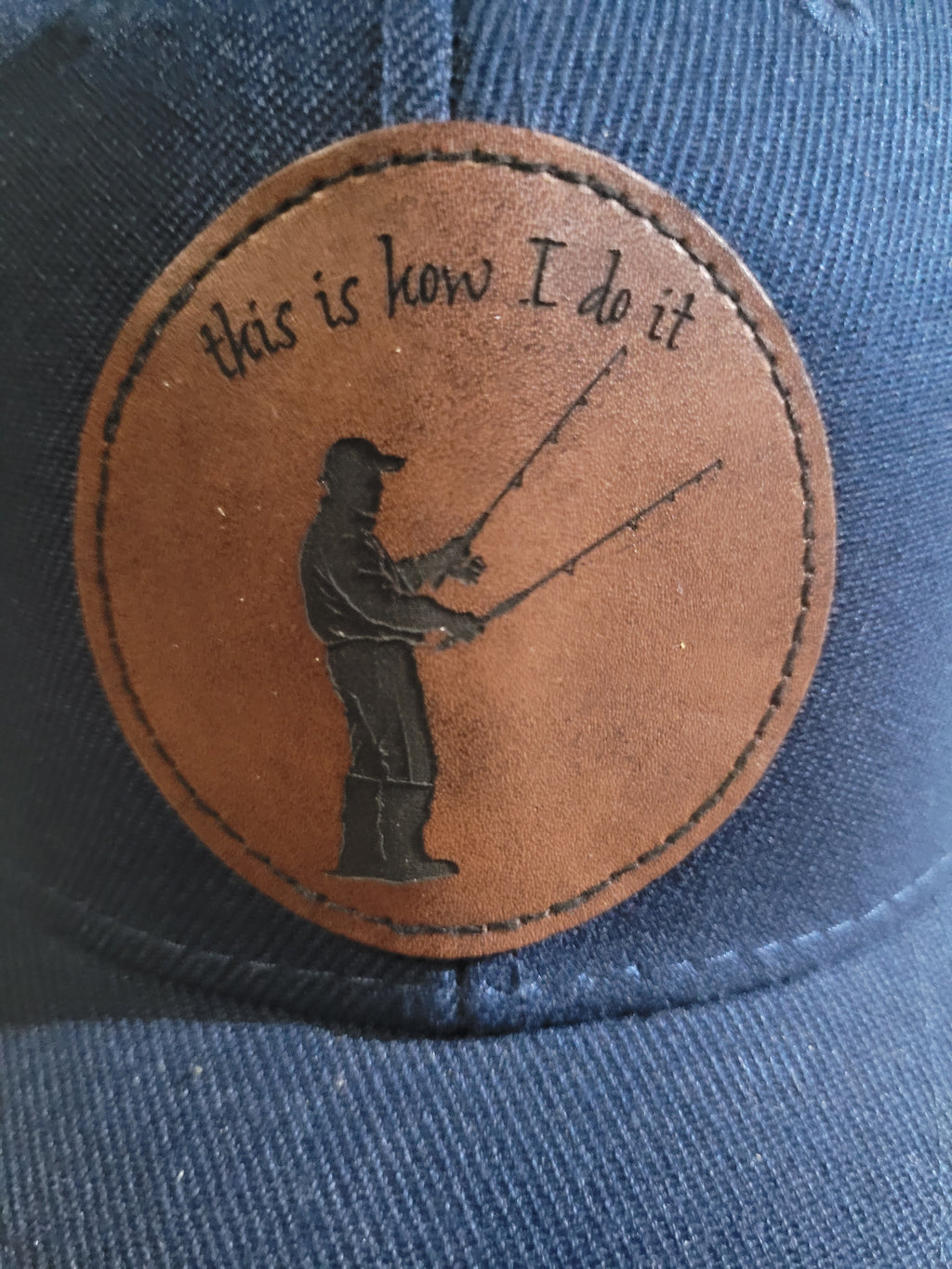 Blue Ball Cap with Patch of a Fisherman with two rods in his hands "This is How I do it"