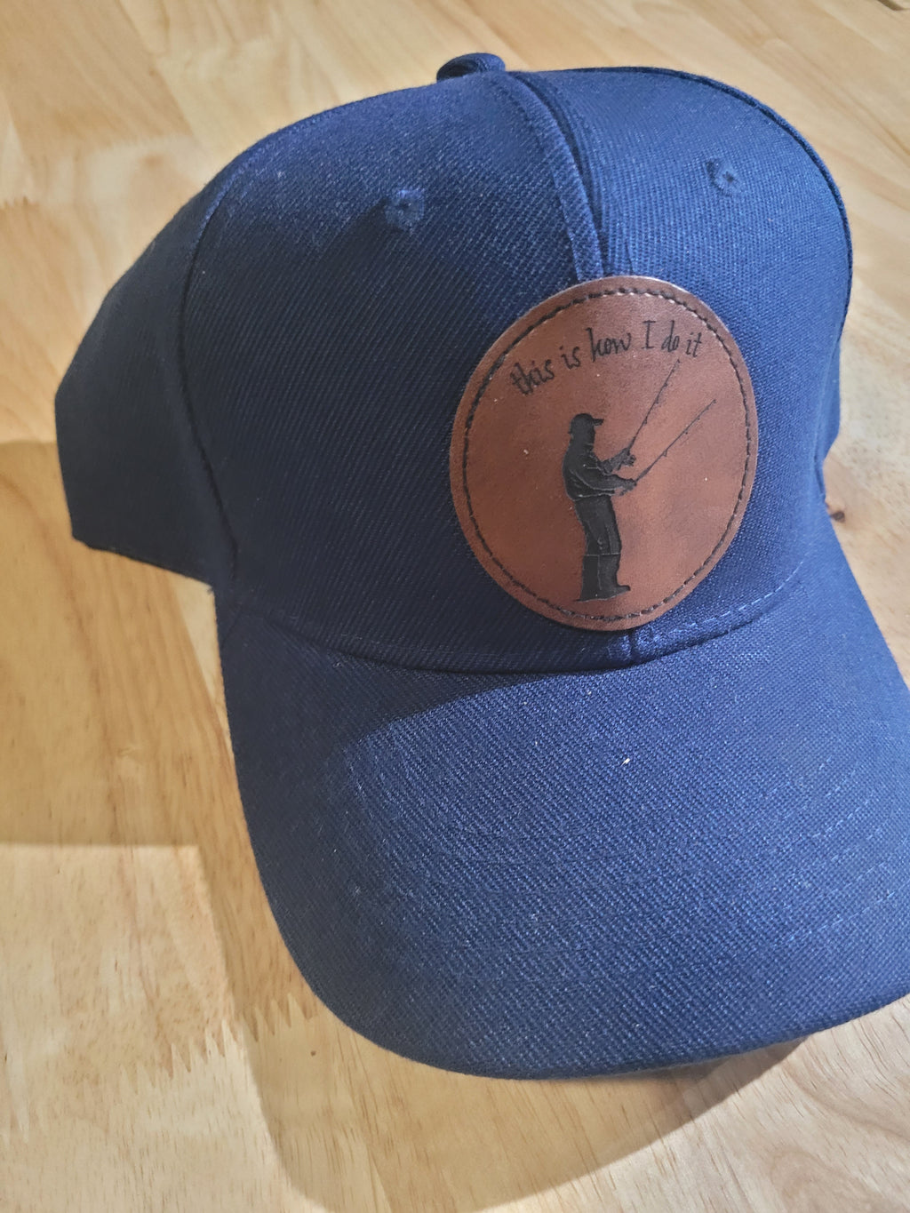 Blue Ball Cap with Patch of a Fisherman with two rods in his hands "This is How I do it"