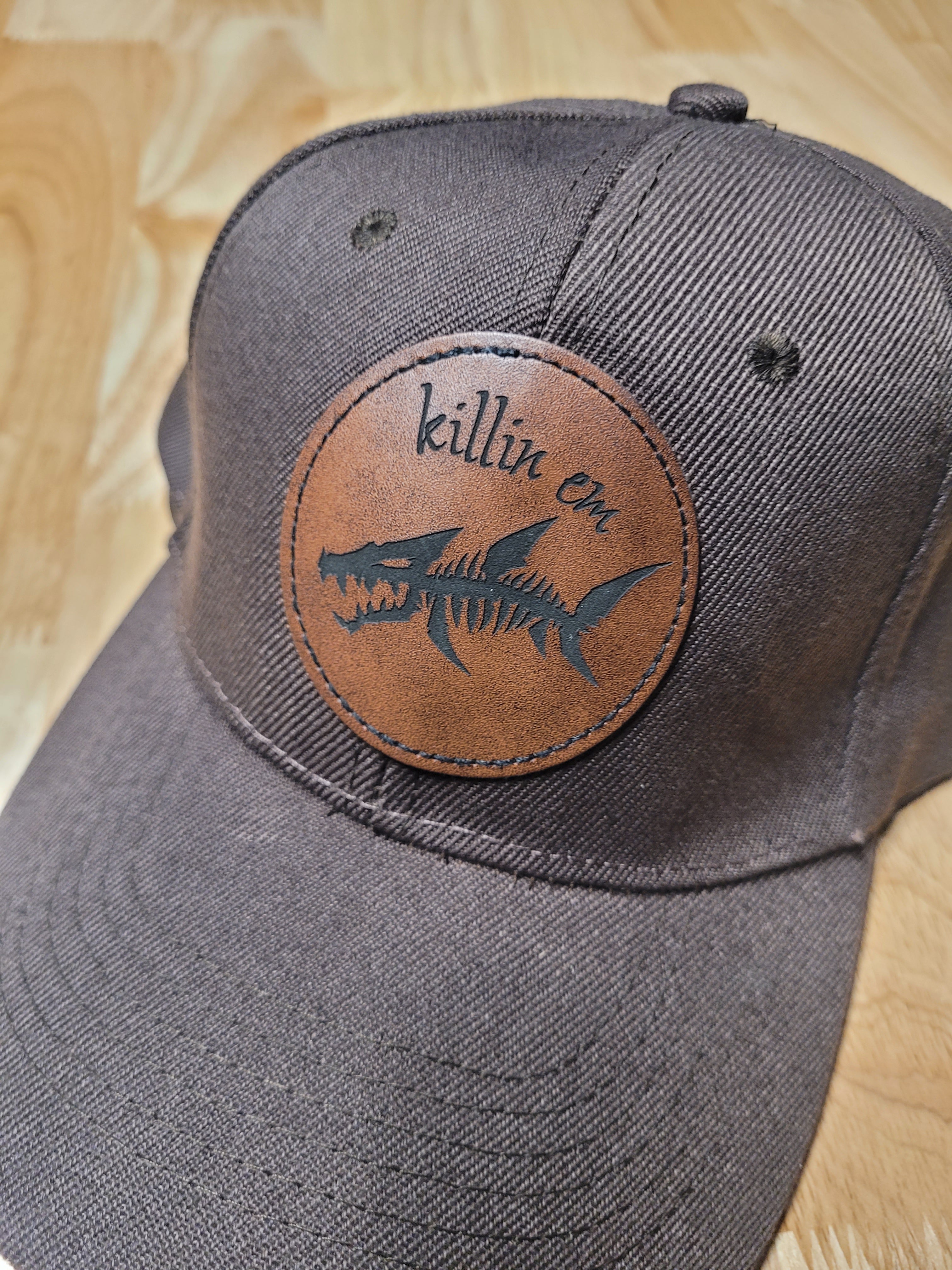 Brown Ball Cap with a fish skeleton patch saying "killin em"