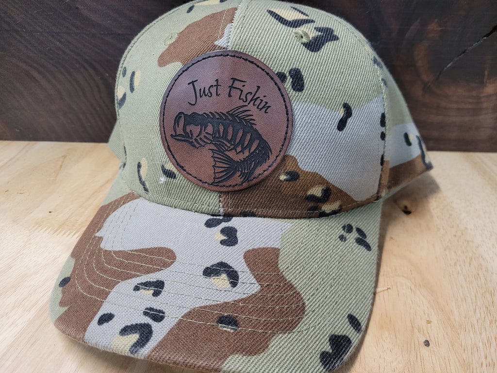 Desert Camo Ball Cap with an engraved fish skeleton patch saying "Just Fishin"