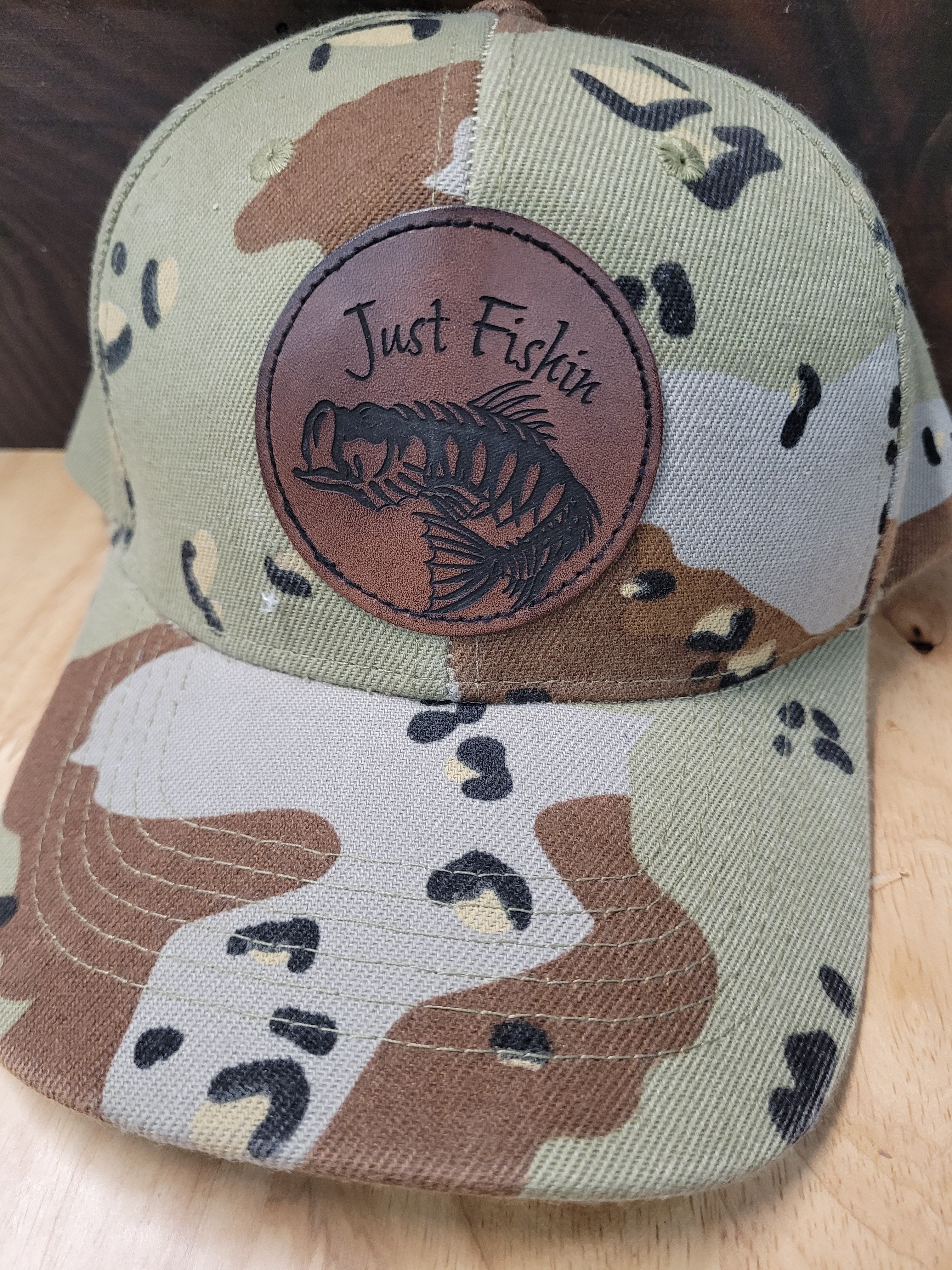 Desert Camo Ball Cap with an engraved fish skeleton patch saying "Just Fishin"