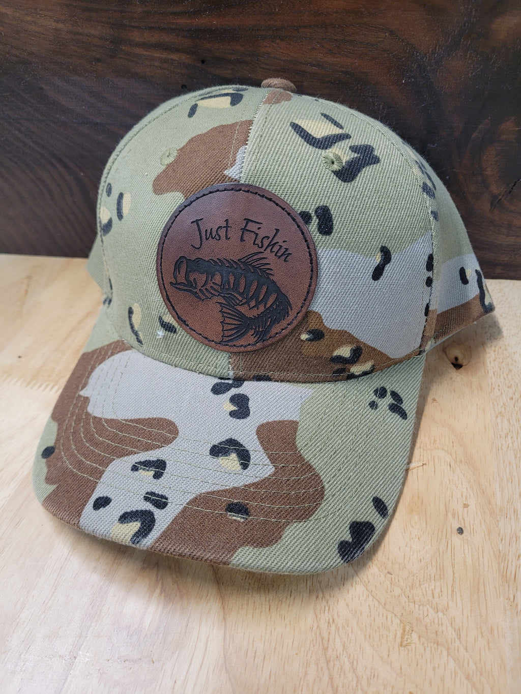 Desert Camo Ball Cap with an engraved fish skeleton patch saying "Just Fishin"