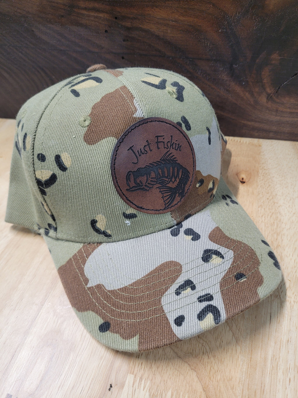 Desert Camo Ball Cap with an engraved fish skeleton patch saying "Just Fishin"