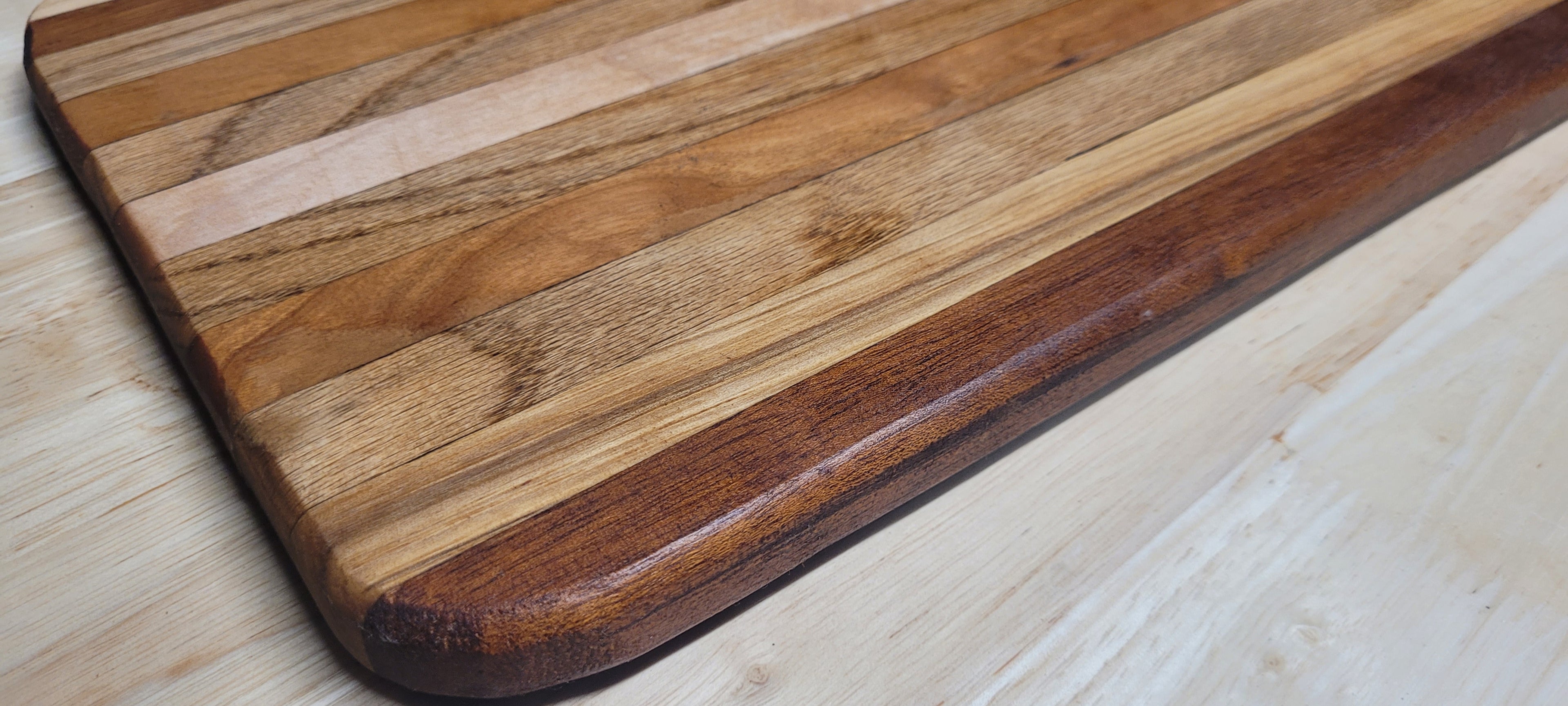 Multi Wood Charcuterie Board Oak, Maple, and Mahogany woods Approximately 19.5"L X 9.5"W