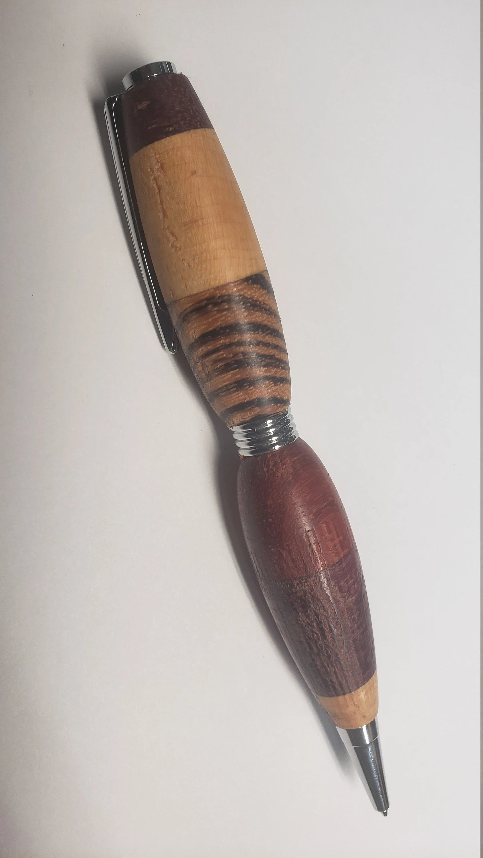 Multi Wood Twist Pen made of  Zebrawood, Padauke Wood, Maple, and Purpleheart Woods